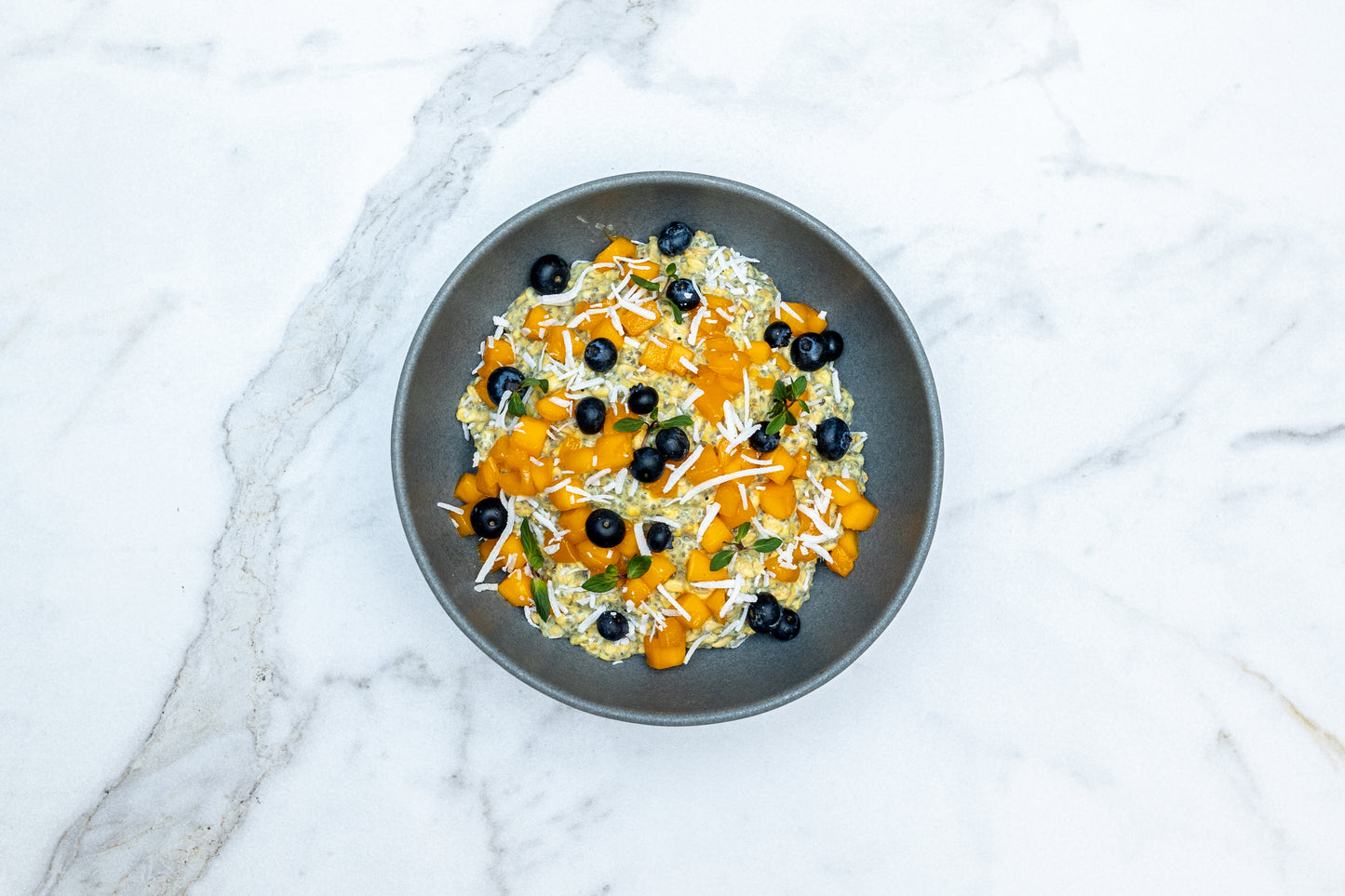 Mango Overnight Oats Topped with Blueberry and Coconut