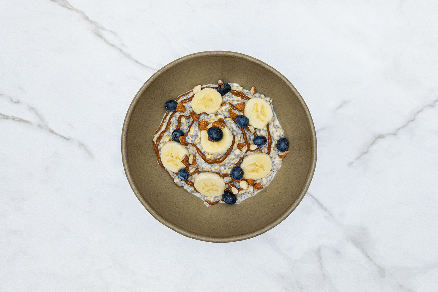 Chia Overnight Oats Topped with Almond Butter, Banana, and Blueberry